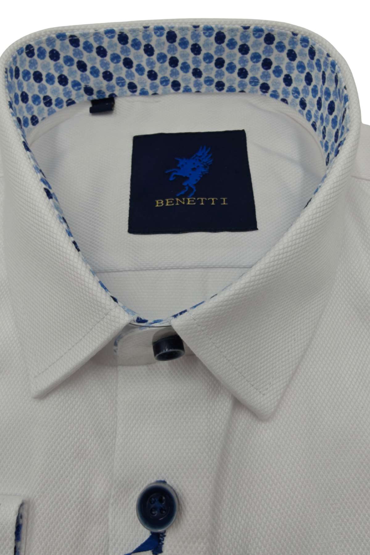 Close-up of a boys white shirt collar with a blue and white patterned inner lining and Benetti label.