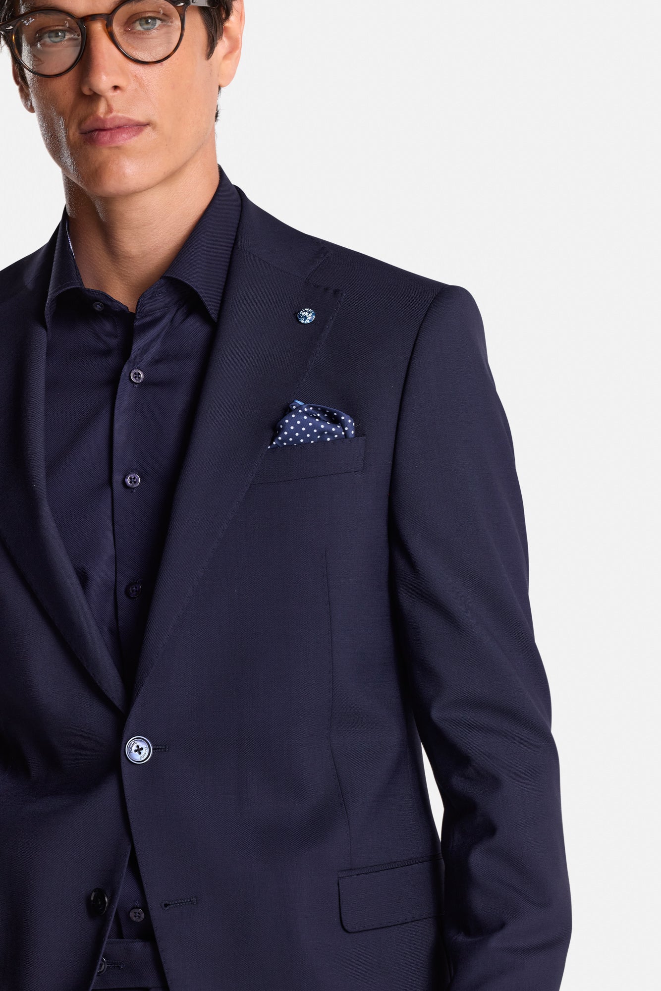 Man wearing a navy suit with a white background