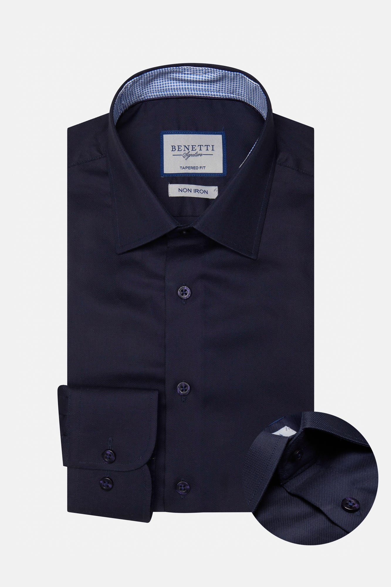 Folded navy blue dress shirt with a close-up of the collar on a light gray background