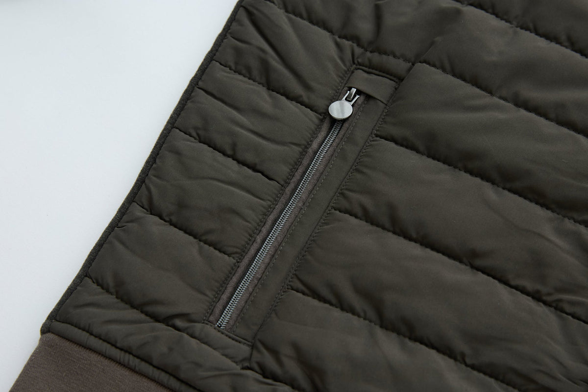 6th Sense Cloud Hybrid Full Zip Peat Jacket side pocket with a zipper closure and a circular pull tab on the quilted panel.