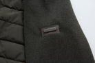 6th Sense Cloud Hybrid Full Zip Peat Jacket detail showing the brand's name on a metal plaque stitched to the sleeve.