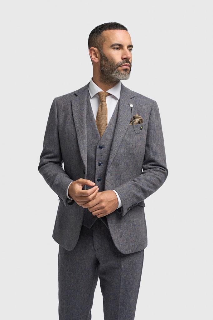 Man wearing a gray suit with a white shirt and brown tie on a light gray background