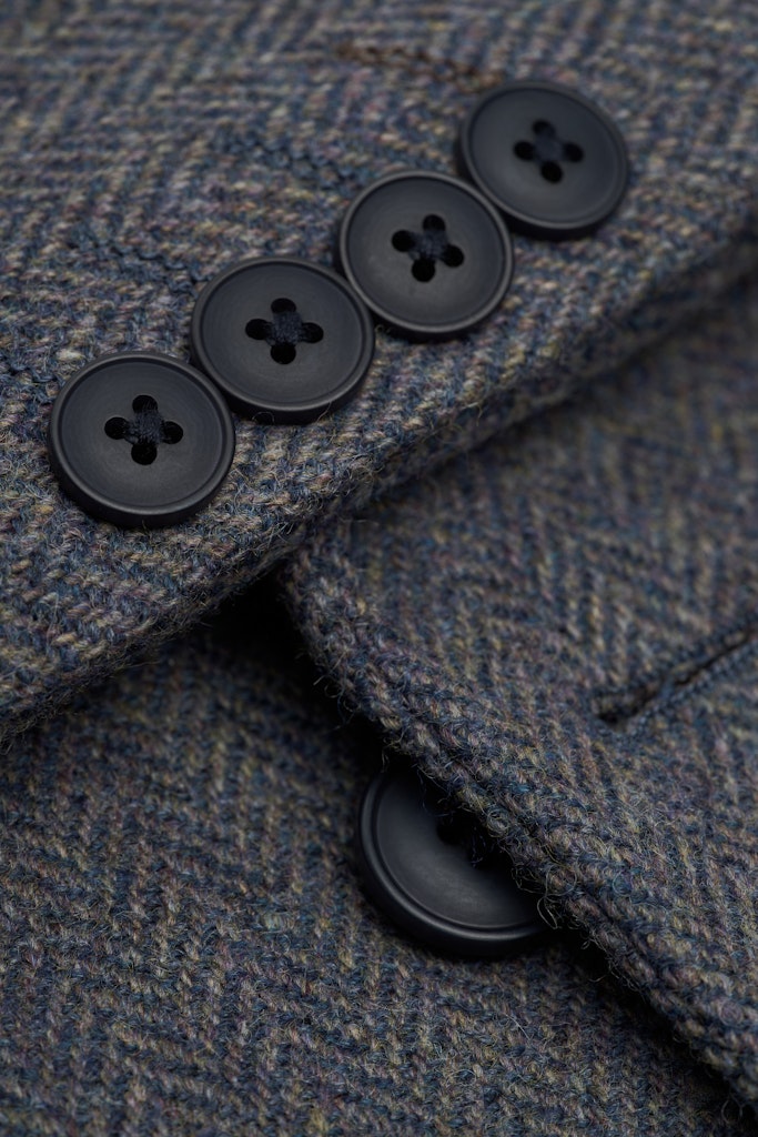 Close-up of a textured fabric with black buttons