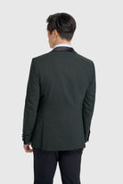 Man wearing a olive tuxedo suit on a white background