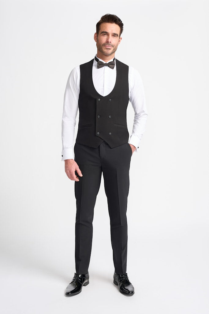 Man wearing a black double breasted waistcoat with a white shirt on a white background