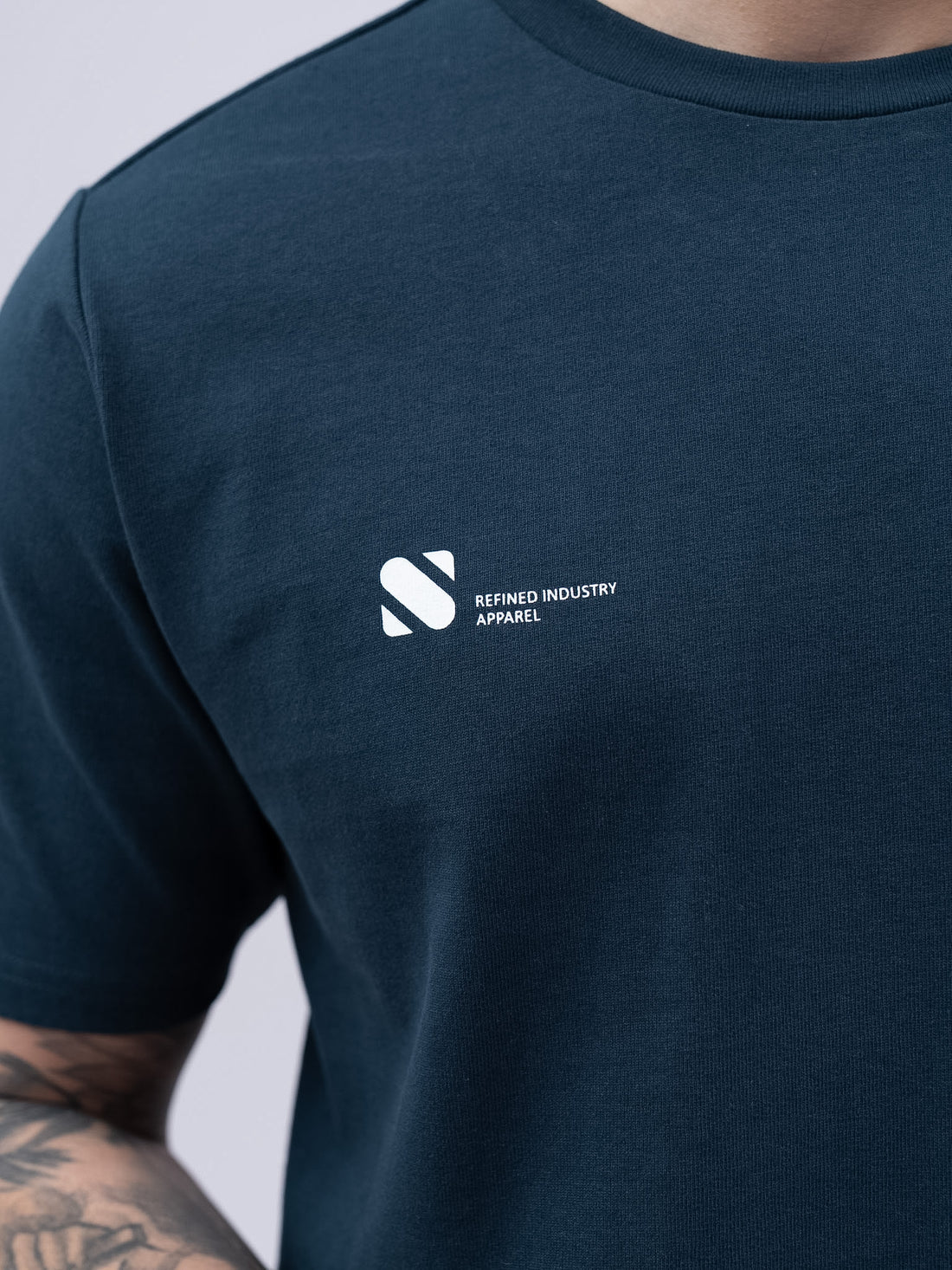 Navy blue t-shirt with a white logo on a plain background