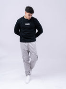 Supreme Being Element black crew-neck sweatshirt worn by model, front view