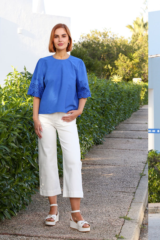 Back view of the Enid cropped wide leg white jeans on model
