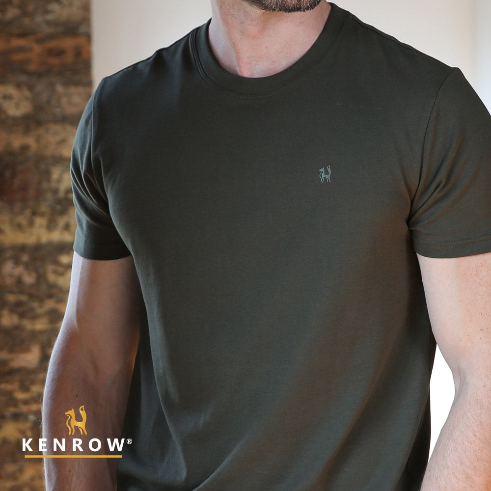 Man wearing a dark green t-shirt with a small logo on a neutral background, featuring the brand 'Kenrow'.