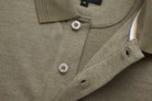 Close-up of 6th Sense Evoke Brindle Polo in brindle showing two buttons on the placket and inner neck tape.