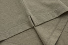 Detailed view of the brindle 6th Sense Evoke Polo side seam and hem stitching.