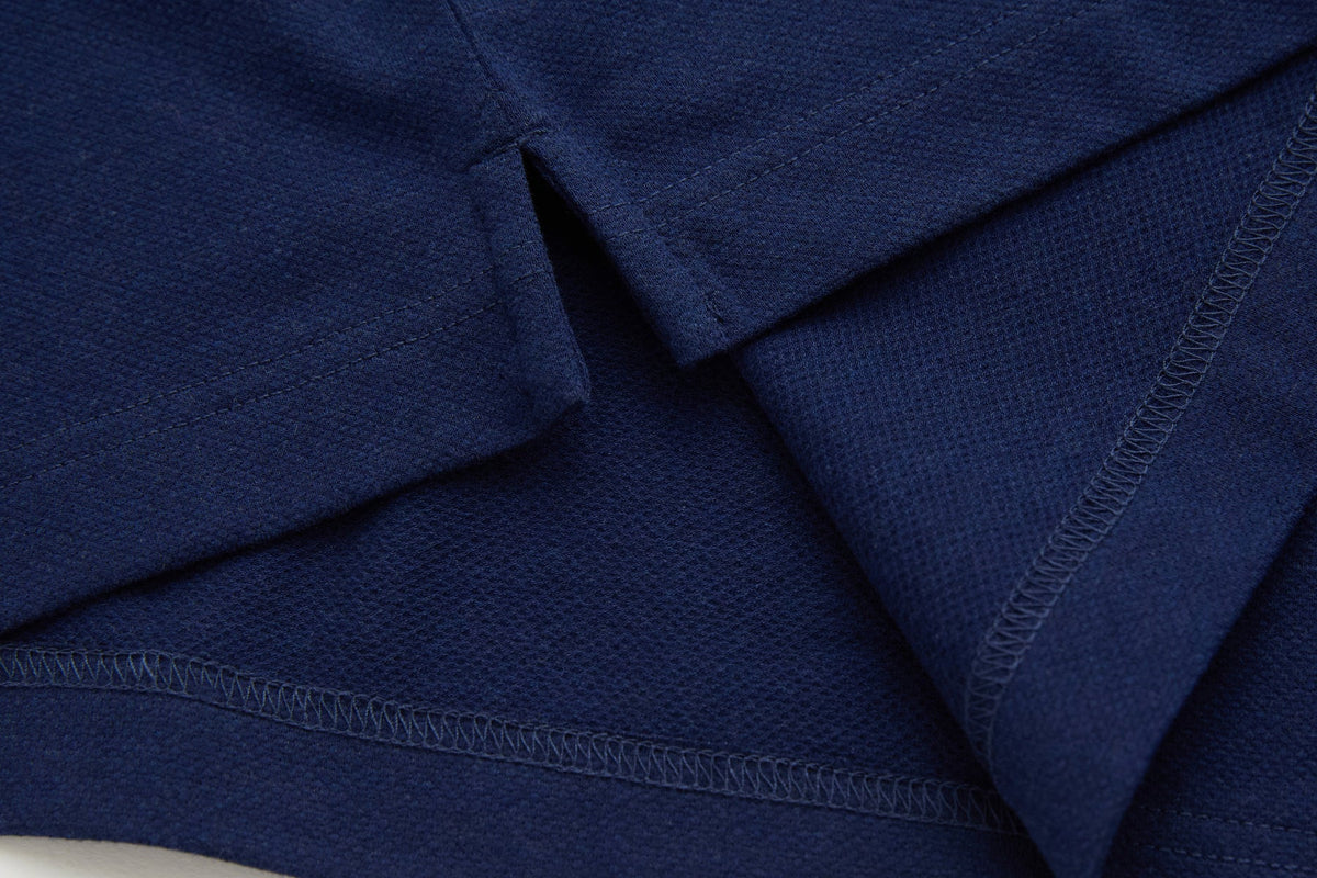Fabric and stitched seams of the 6th Sense Evoke dress blue polo