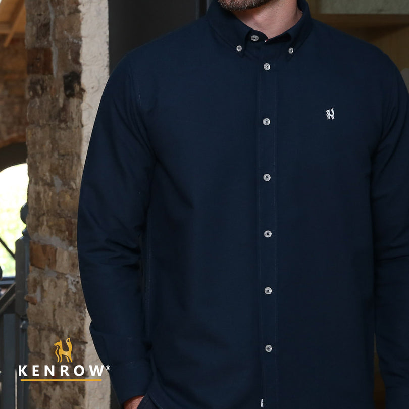 Close up of a man wearing a navy coloured shirt