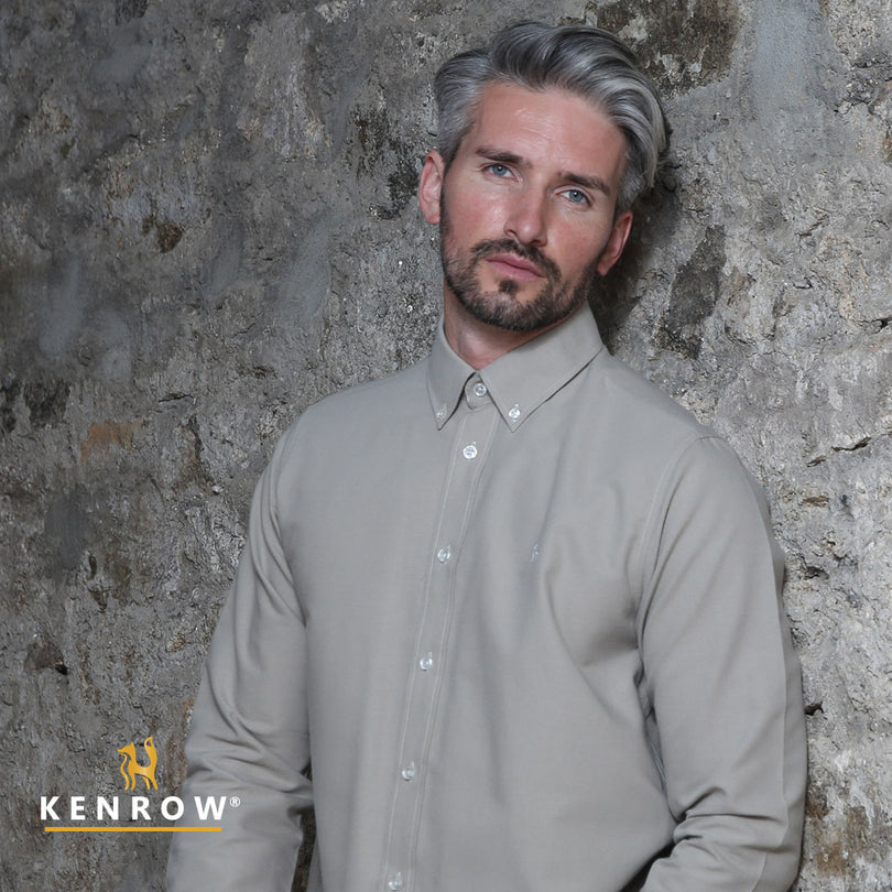 Close up of a man wearing a putty coloured shirt