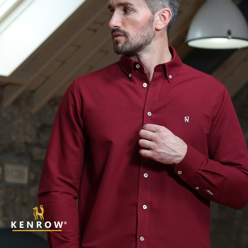 Man wearing a ruby coloured shirt, looking right