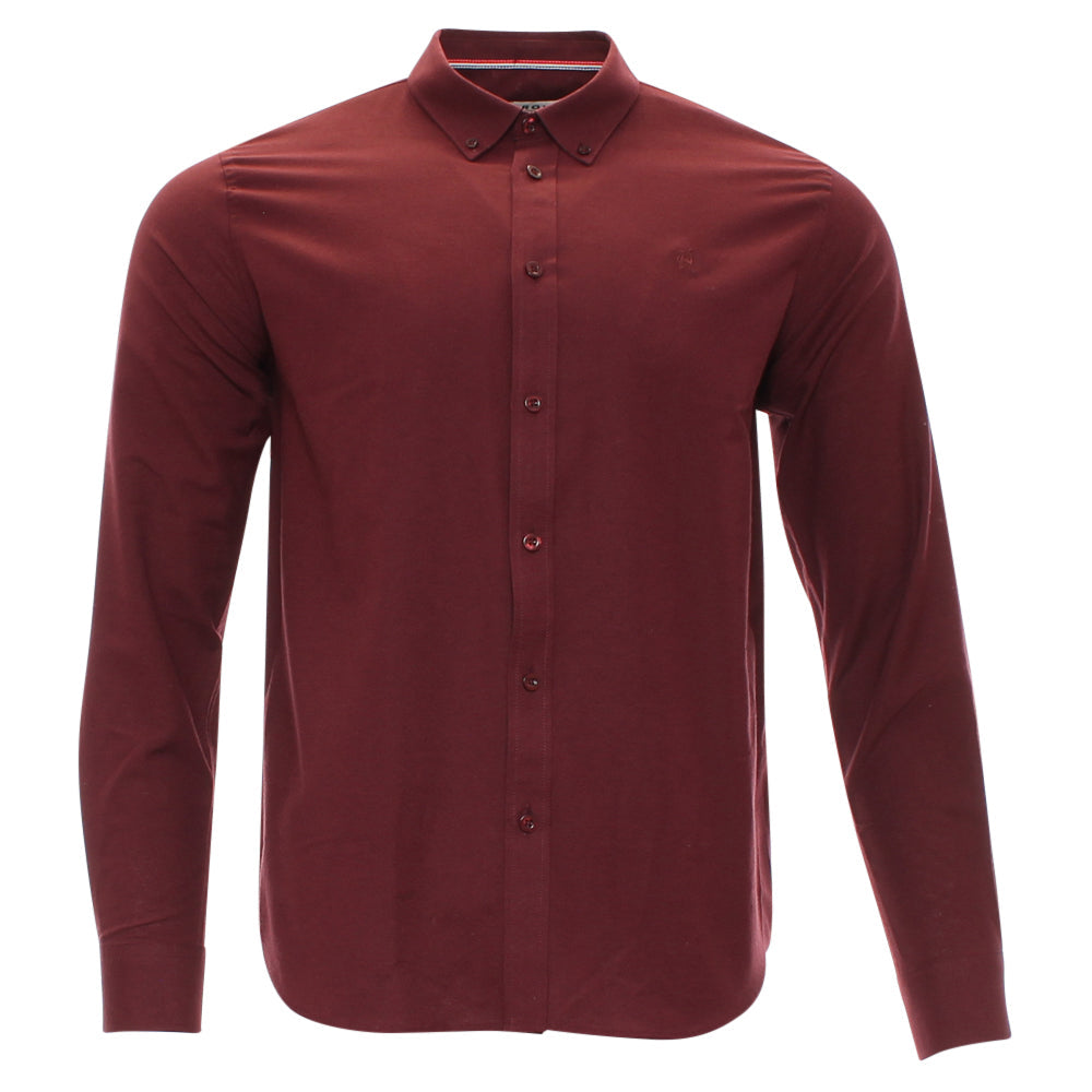 A long-sleeve button-down shirt in a deep burgundy red, featuring a classic pointed collar and a subtle embroidered logo on the left chest, displayed on a clean white background.