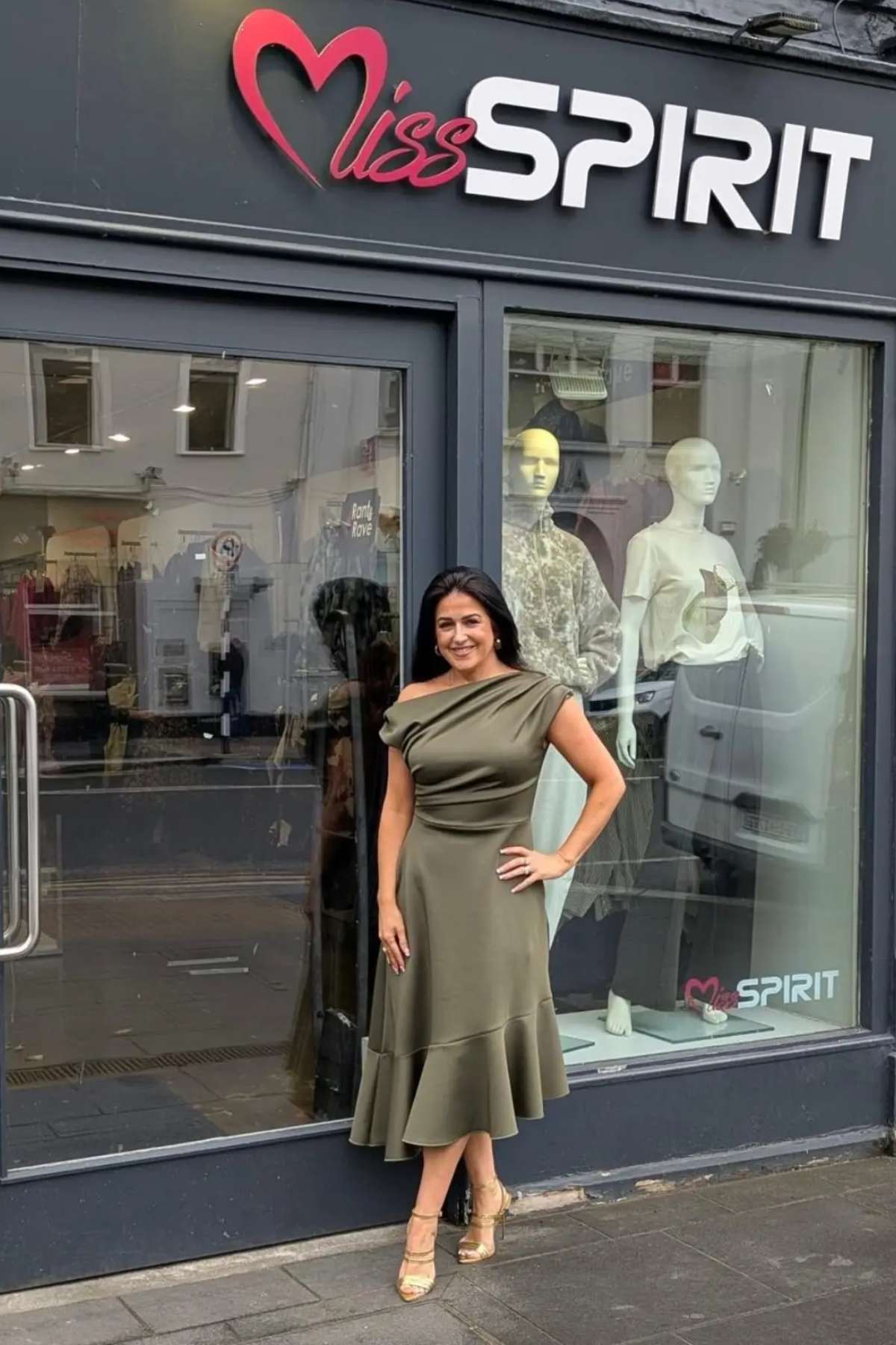 Tina is wearing the Felicity Asymmetric Frill Khaki Midi Dress