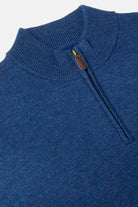 Close-up of a Benetti Franco INDIGO 1/4 zip knit with ribbed collar and leather zip pull.