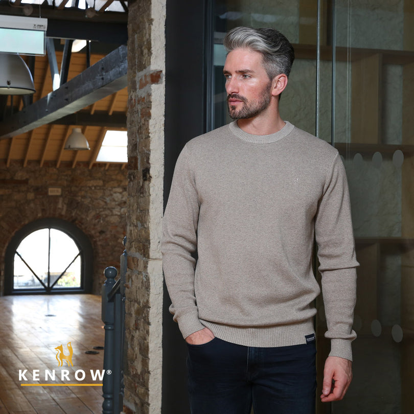 Man wearing a sand colour crew neck jumper looking right