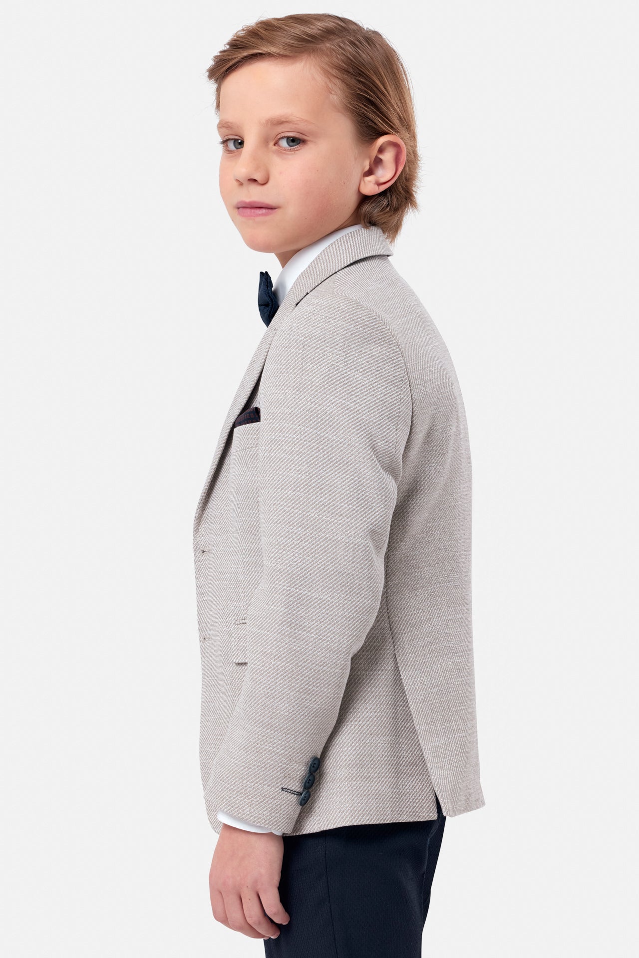 Boy wearing a beige textured blazer-Side view