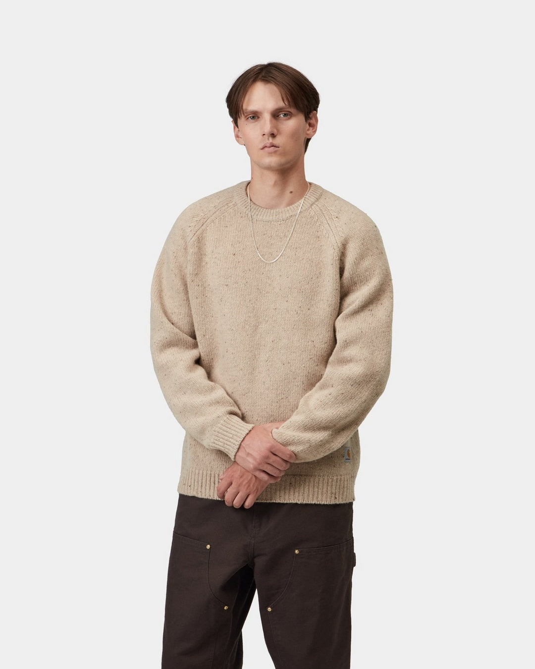 Carhartt WIP Anglistic Sweater in Speckled Fleur de Sel, shown front view on model with ribbed cuffs and hem.
