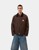 Carhartt WIP Detroit Jacket in Tobacco / Black, front view with black corduroy collar, gold-tone zip and chest pocket logo patch, shown on model.