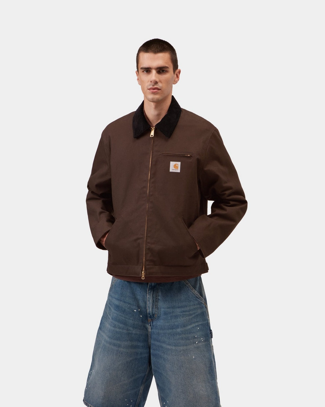 Carhartt WIP Detroit Jacket in Tobacco / Black, front view, with black corduroy collar, gold-tone zip, and chest pocket logo patch, shown on model.