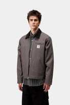 Front model view of the Carhartt WIP Detroit Jacket in graphite and black