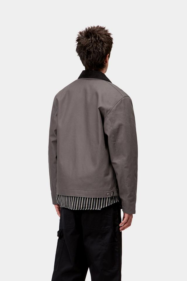 Person wearing a gray jacket with a white background