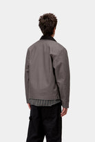 Angled model view of the Carhartt Detroit Jacket in graphite and black