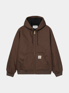 Carhartt WIP Active Jacket in Tobacco, front view. The hooded jacket features a full-length brass zip, drawstring hood, ribbed cuffs and hem, and a kangaroo pocket with a square Carhartt label.