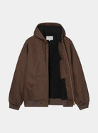 Carhartt WIP Active Jacket in Tobacco, front view with open zip. The jacket has a hood with drawstring, ribbed cuffs and hem, a front pocket, and a gold-tone zip. The black quilted lining and inner Carhartt WIP label are visible.