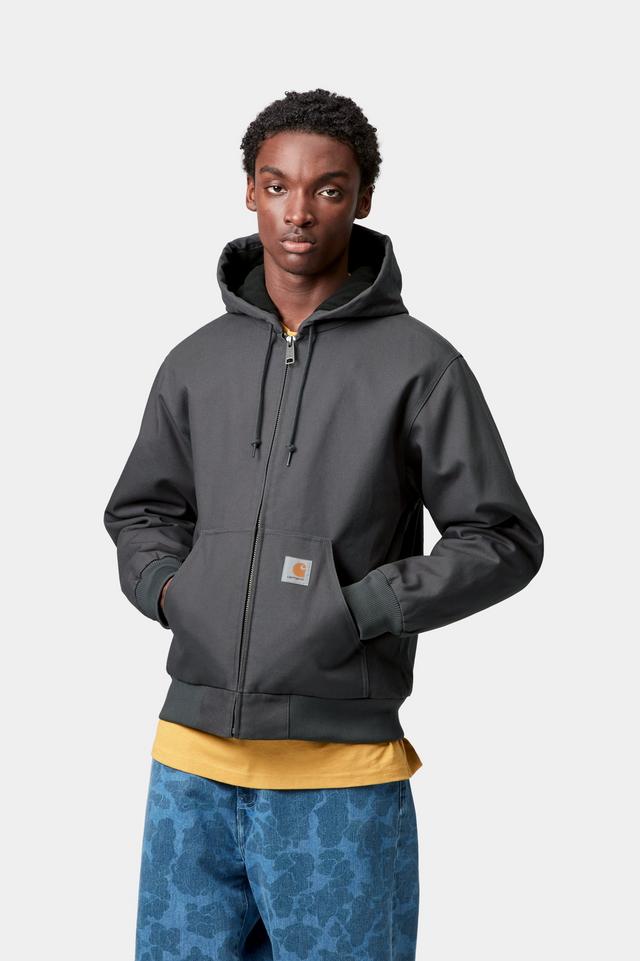 Person wearing a dark gray hoodie jacket with a white background