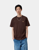 Carhartt WIP S/S Chase T-Shirt in Palisander / Gold, worn by model in front view with small gold chest logo.
