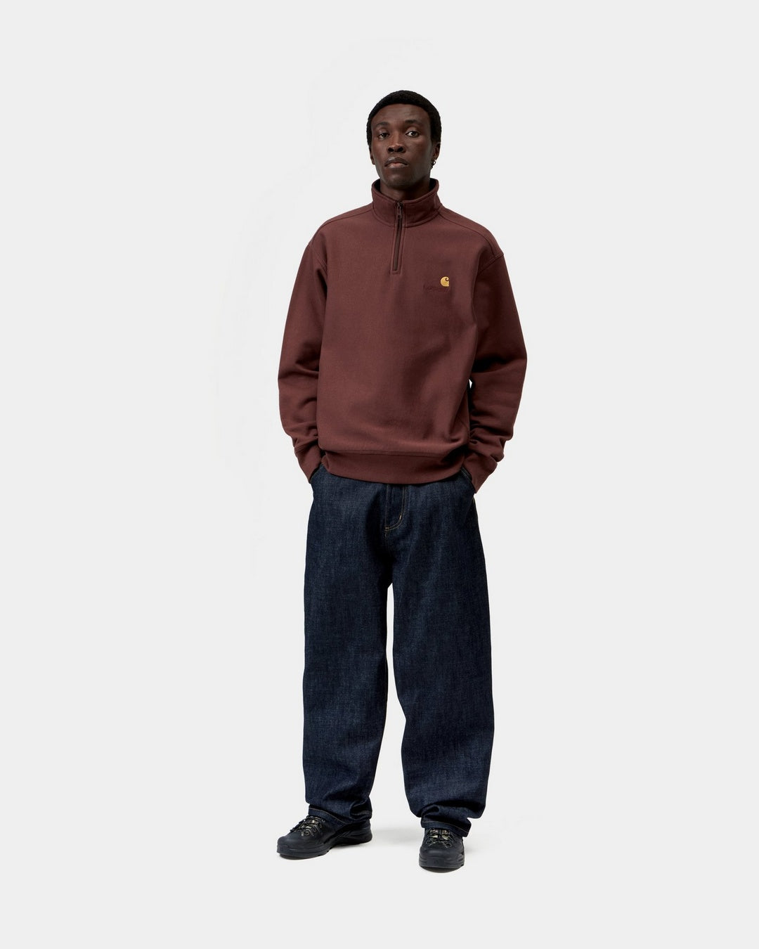 Carhartt WIP Half Zip American Script Sweatshirt in Amarone, shown on model with half-zip high neck and small chest logo.