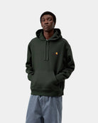 Carhartt WIP Hooded American Script Sweatshirt in Raven, front view, with kangaroo pocket and logo chest embroidery, shown on model.