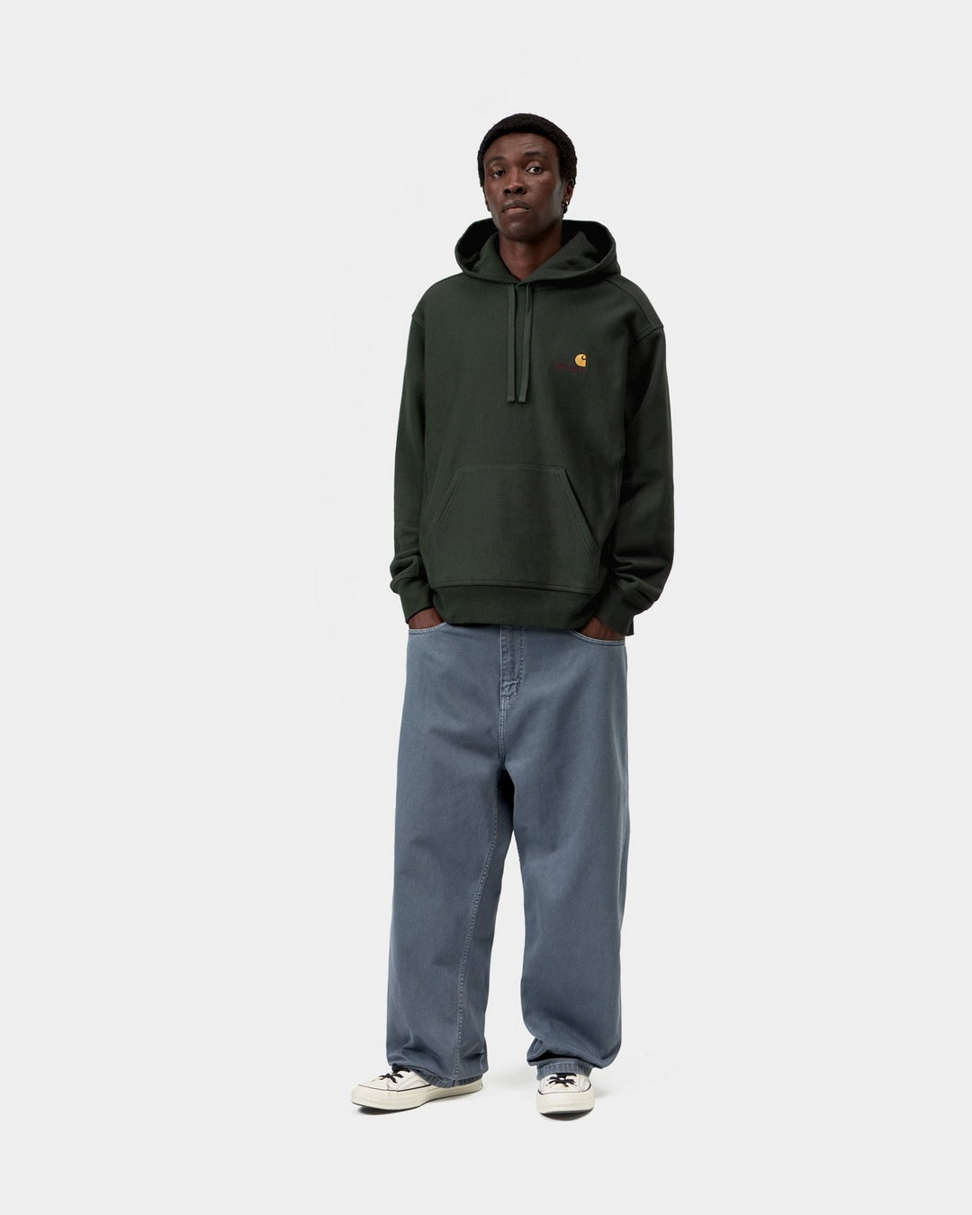 Carhartt WIP Hooded American Script Sweatshirt in Raven, front view, worn by model with kangaroo pocket and logo embroidery on chest.