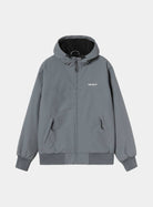 Front view of the Carhartt WIP Hooded Sail Jacket in Styx / White, showing a zip front, drawstring hood, two zipped side pockets, white Carhartt logo on the chest, and rib-knit cuffs and hem.