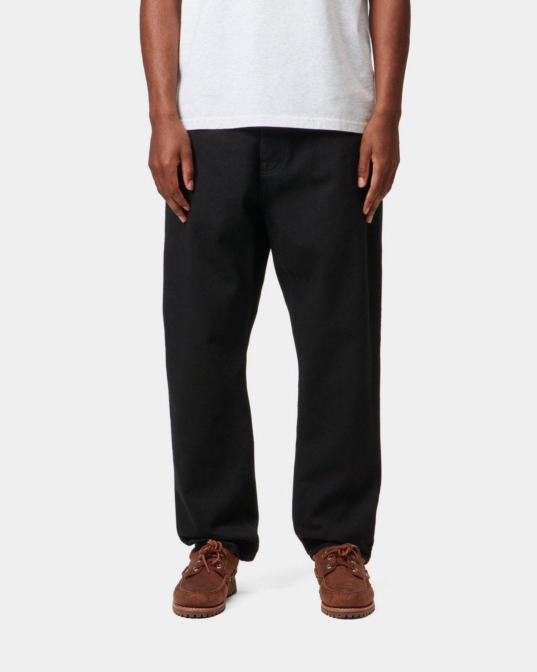 Carhartt WIP Newel Pant in black, shown on model from the front.