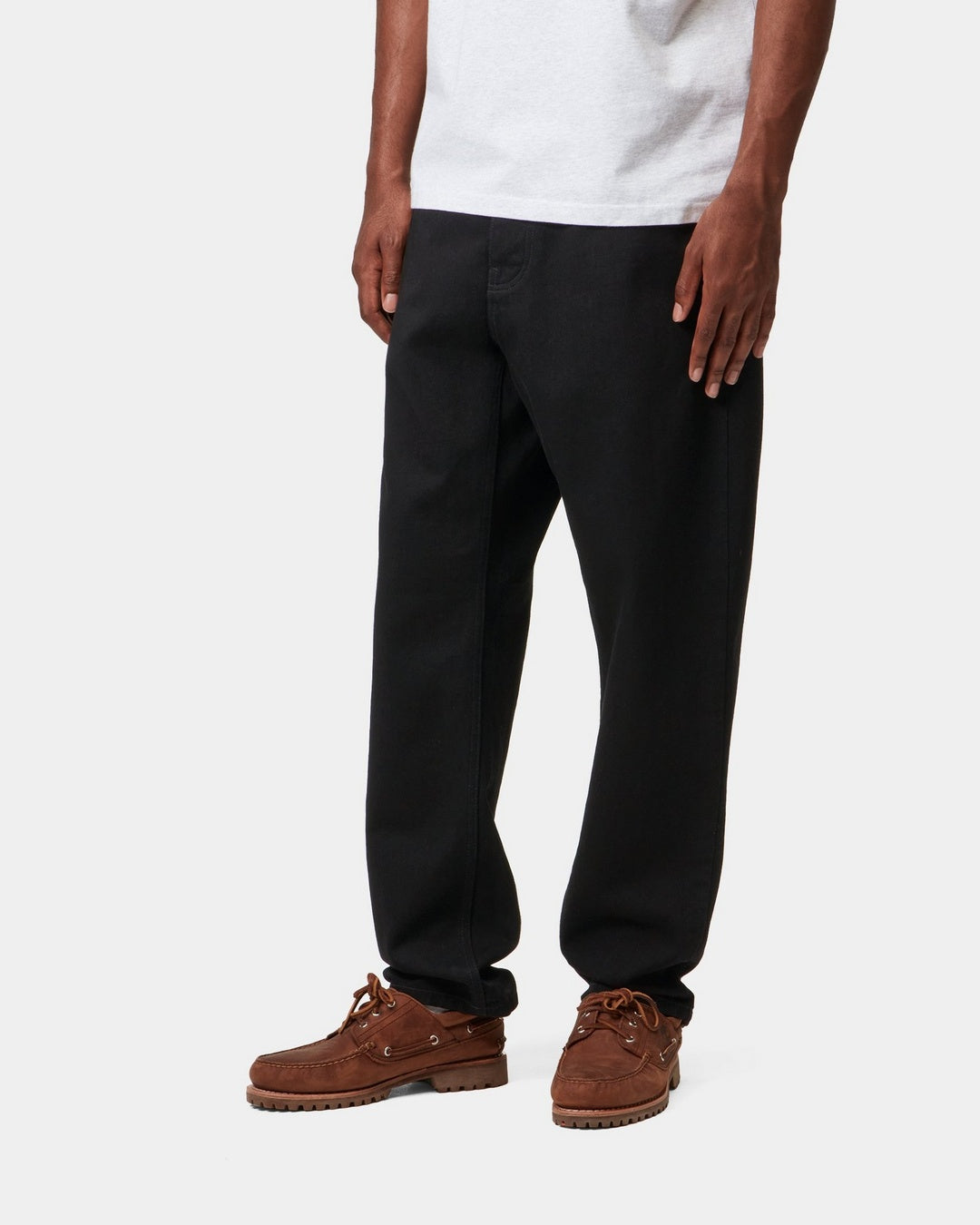 Carhartt WIP Newel Pant in Black, shown on model with a relaxed tapered fit.
