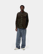Carhartt WIP L/S Madison Cord Shirt in Tobacco, shown worn by model in front view with button-down collar and chest logo visible.