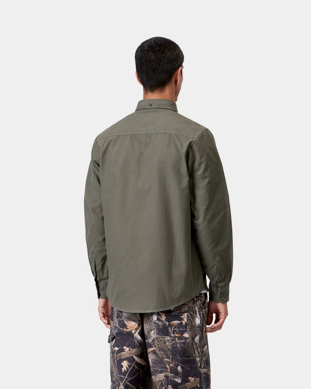 Carhartt WIP L/S Bolton Shirt in Shungite, back view, worn by model with curved hem and button-down collar visible.