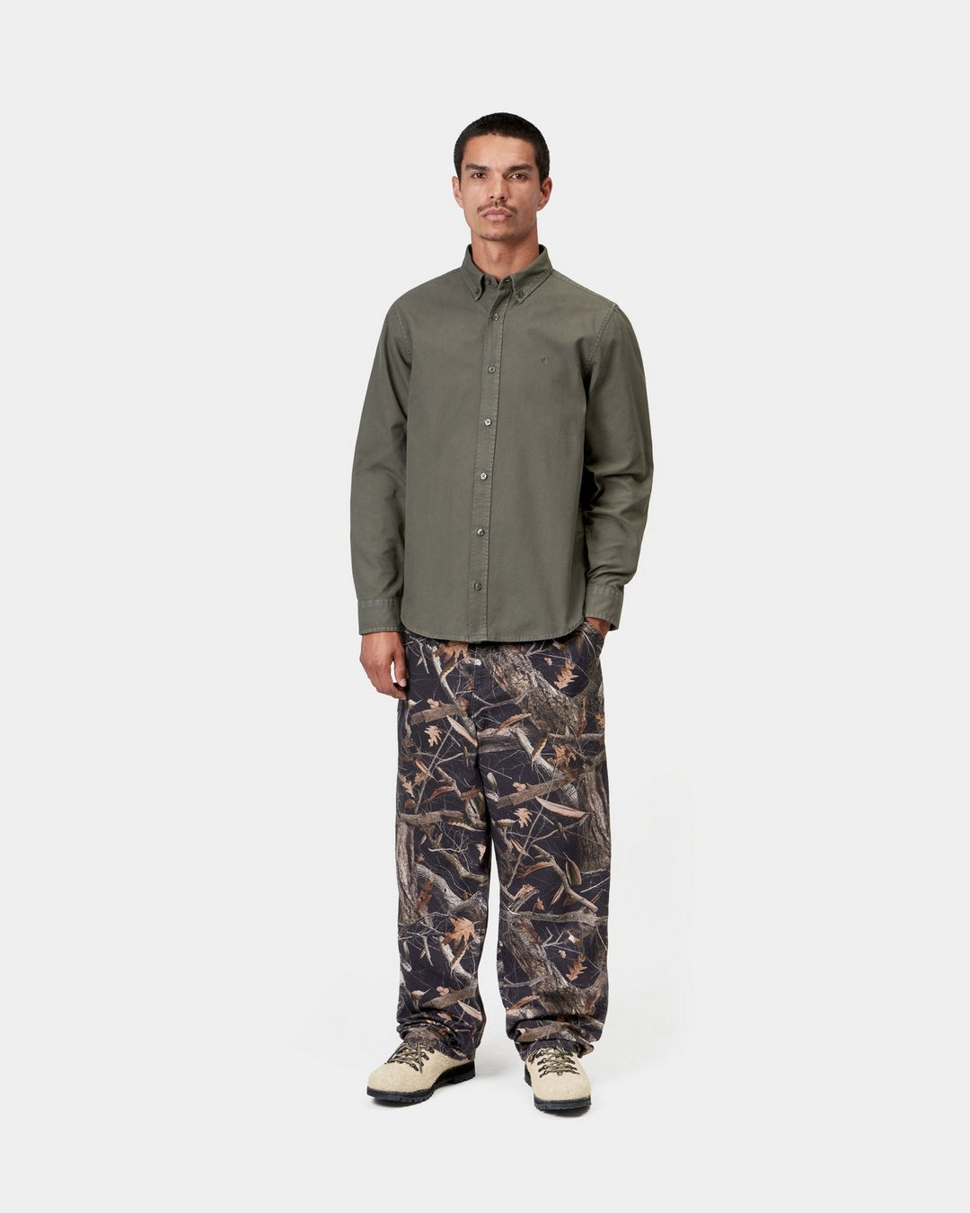 Carhartt WIP L/S Bolton Shirt in Shungite, shown on model with button-down collar and chest logo.