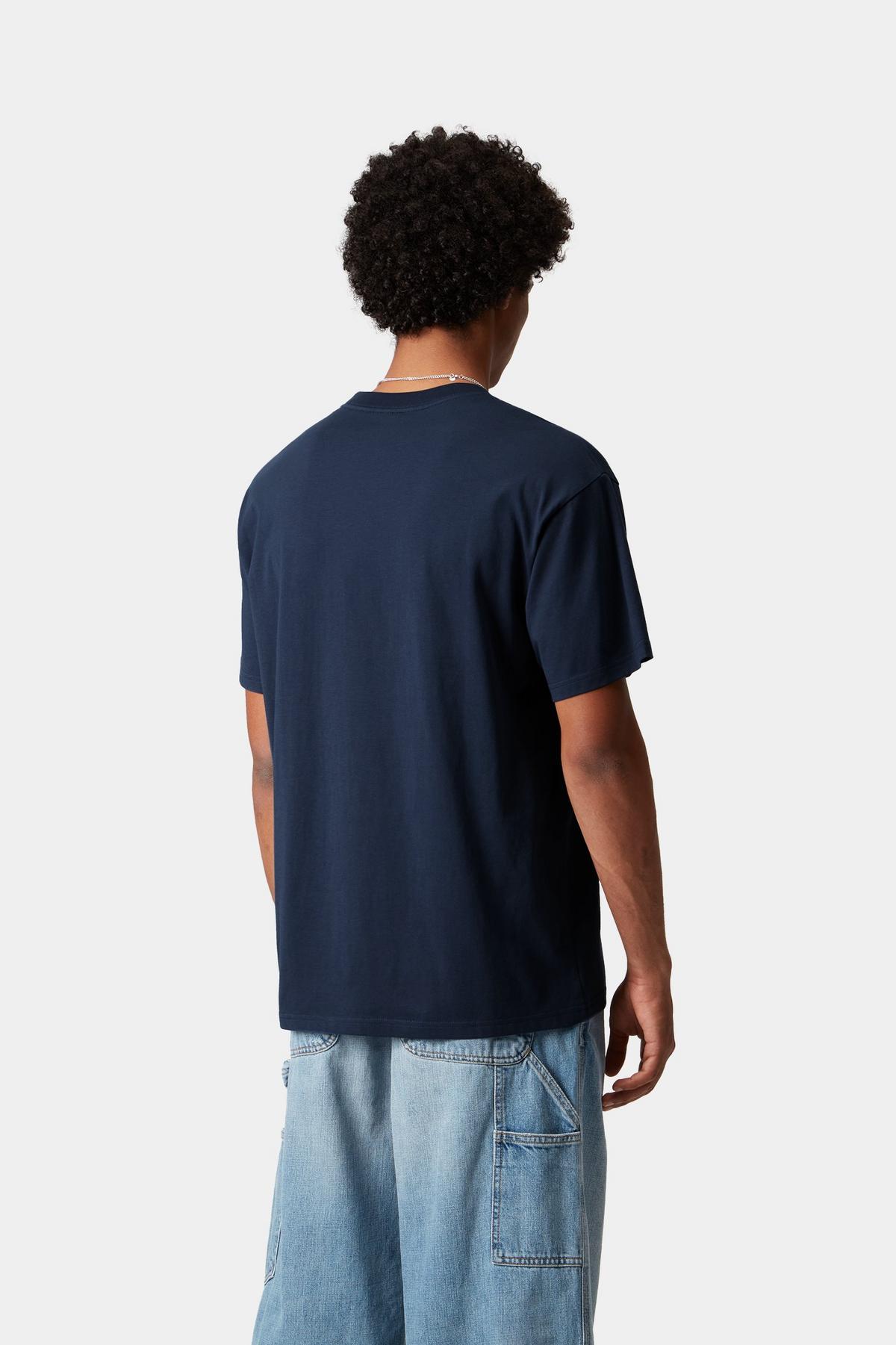 Person wearing a navy blue t-shirt and light blue jeans on a white background-Back view