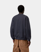 Back view of a Carhartt WIP sweatshirt in Dark Navy / Dark Scarab, worn with ribbed cuffs and hem.