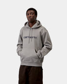 Carhartt WIP Hooded Carhartt Sweatshirt in Shady Grey / Dark Navy, front view, with hood, drawcords, kangaroo pocket and chest logo print, shown on model.