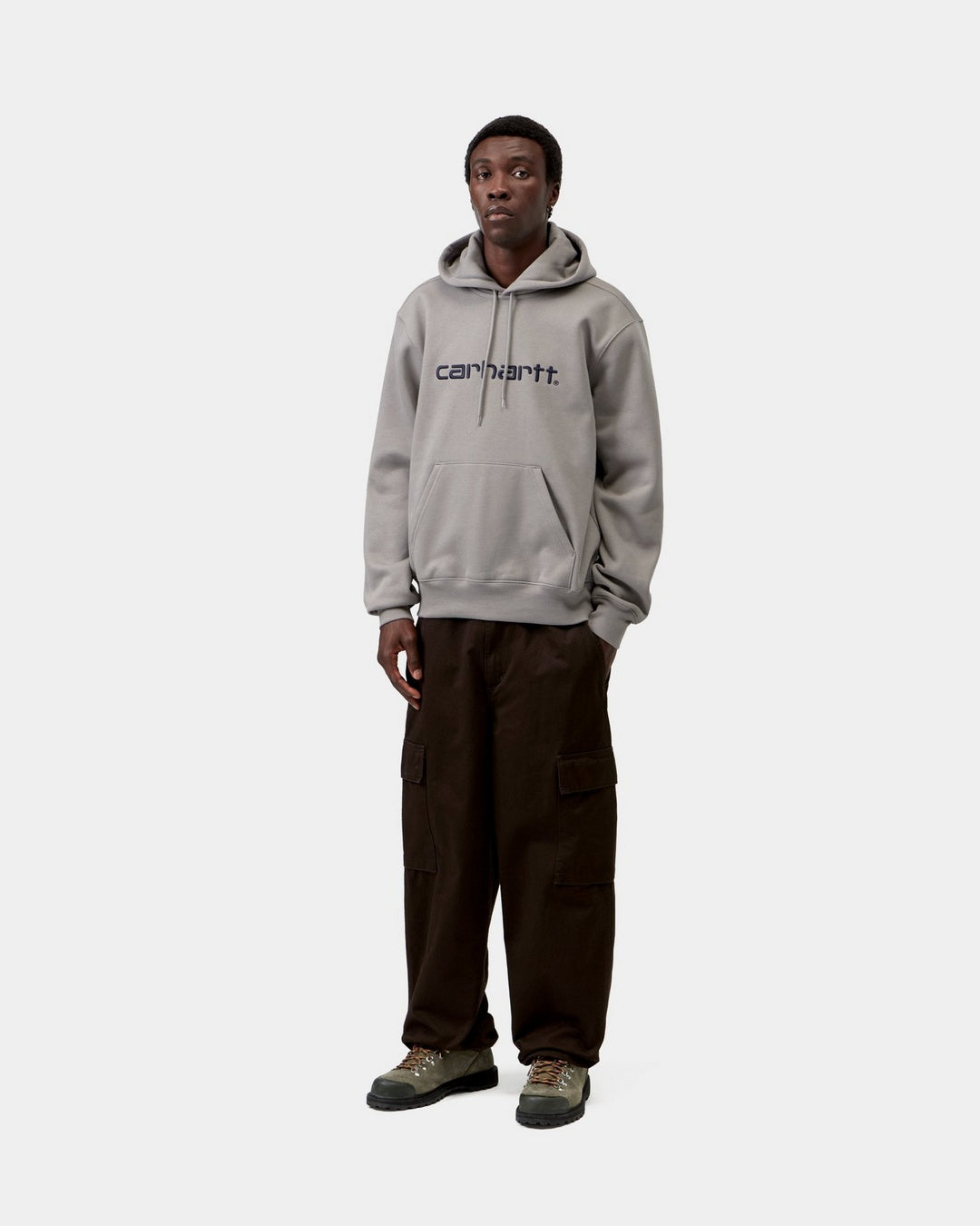 Carhartt WIP Hooded Carhartt Sweatshirt in Shady Grey / Dark Navy, shown worn front view with kangaroo pocket and logo on chest.