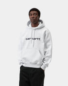 Carhartt WIP Hooded Carhartt Sweatshirt in Ash Heather / Graphite, front view on model with kangaroo pocket and logo on chest.