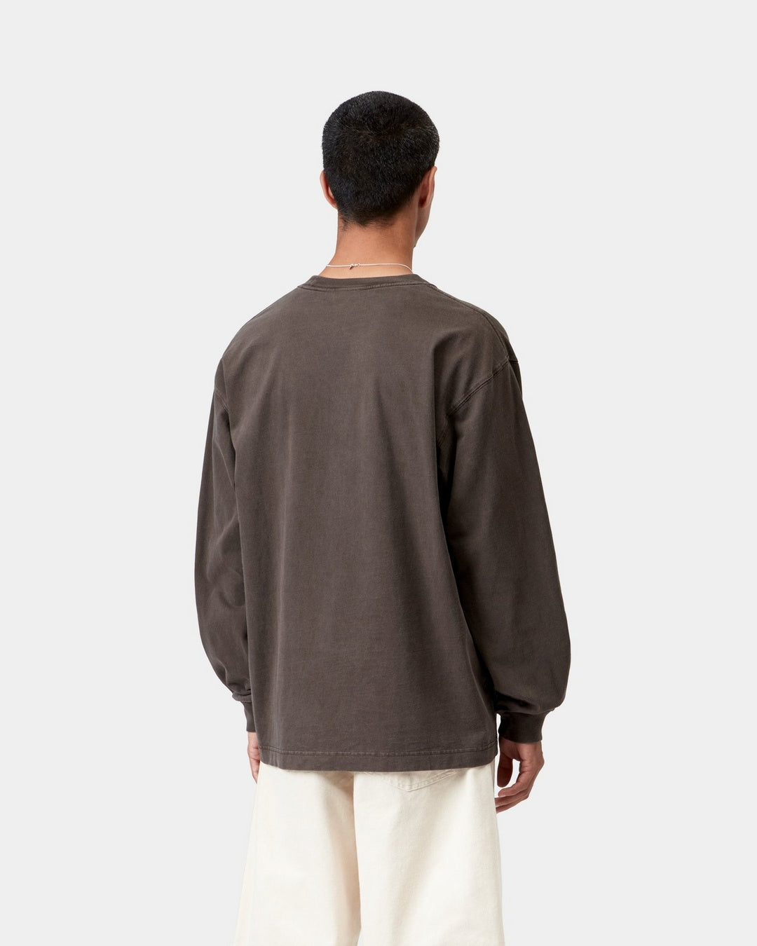 Back view of a Carhartt WIP L/S Vista T-Shirt in Tobacco, showing the loose fit, long sleeves, and ribbed cuffs, shown on model.