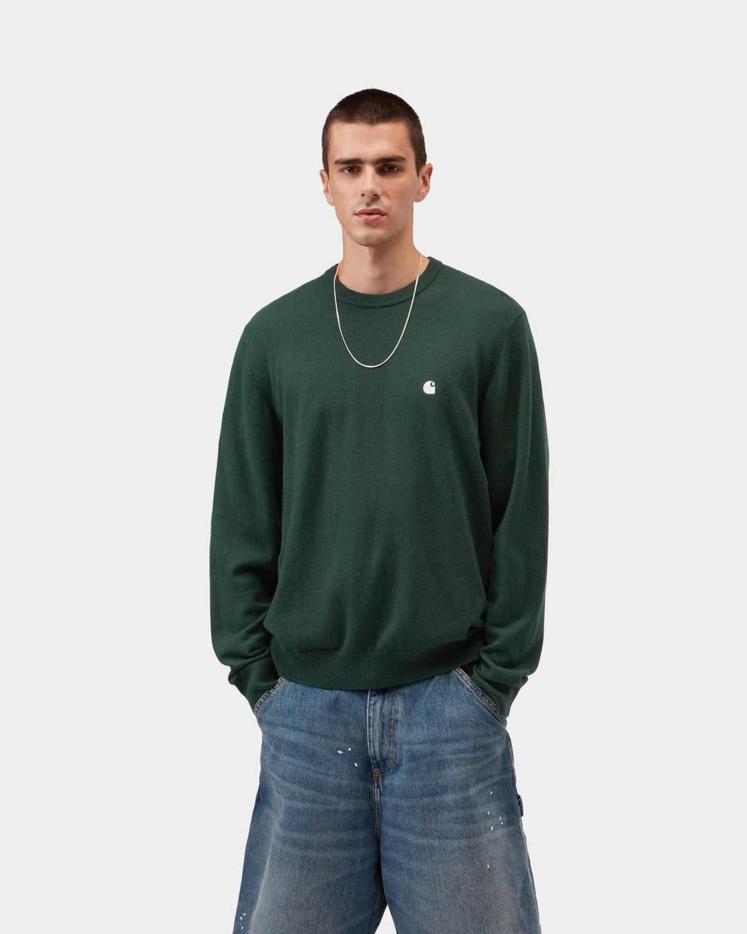 Carhartt WIP Madison Sweater in Dark Scarab / Wax, front view, with a ribbed crew neck and small chest logo, shown on model.